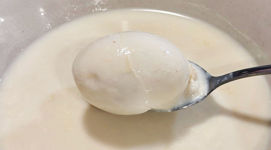 Cooked egg in Fu Zhu Yi Mi sweet soup with silky tofu skin broth 腐竹薏米蓮子雞蛋糖水中的熟雞蛋，湯底順滑細緻