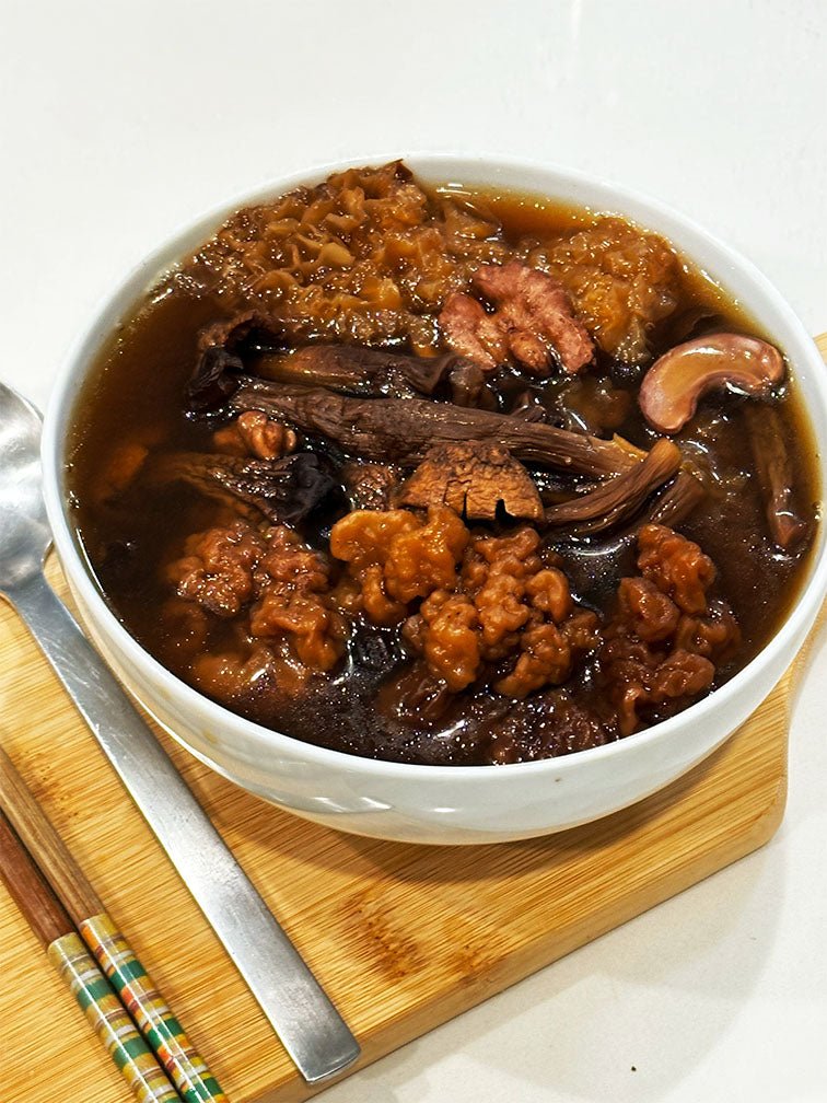 Close-up of prepared Collagen Boost Soup in a bowl - 姬松茸黃耳滋潤湯 offering collagen boosting, liver and kidney recovery benefits with natural ingredients. 一碗已煮好的姬松茸黃耳滋潤湯特寫，提供禦防三高功效，採用天然食材。