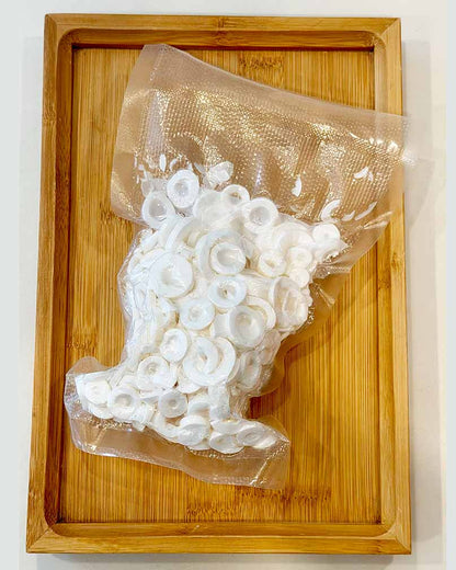 Vacuum-sealed Tong Cao (Rice Paper Plant Pith) dried soup ingredient pack on wooden tray 真空包裝通草（Rice Paper Plant Pith）乾湯料單品放在木盤上