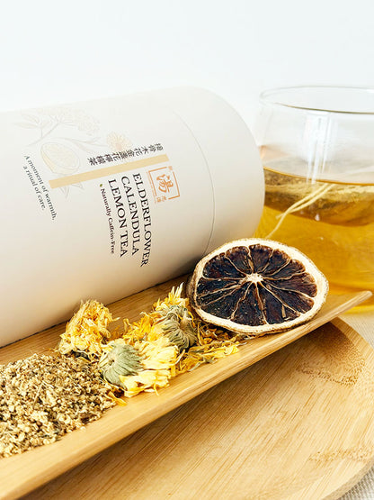 Elderflower Calendula Lemon Flower Tea with dried lemon slice, calendula flowers, elderflower, and brewed flower tea in glass cup 接骨木花金盞花檸檬茶配檸檬片、金盞花、接骨木花及玻璃杯花茶